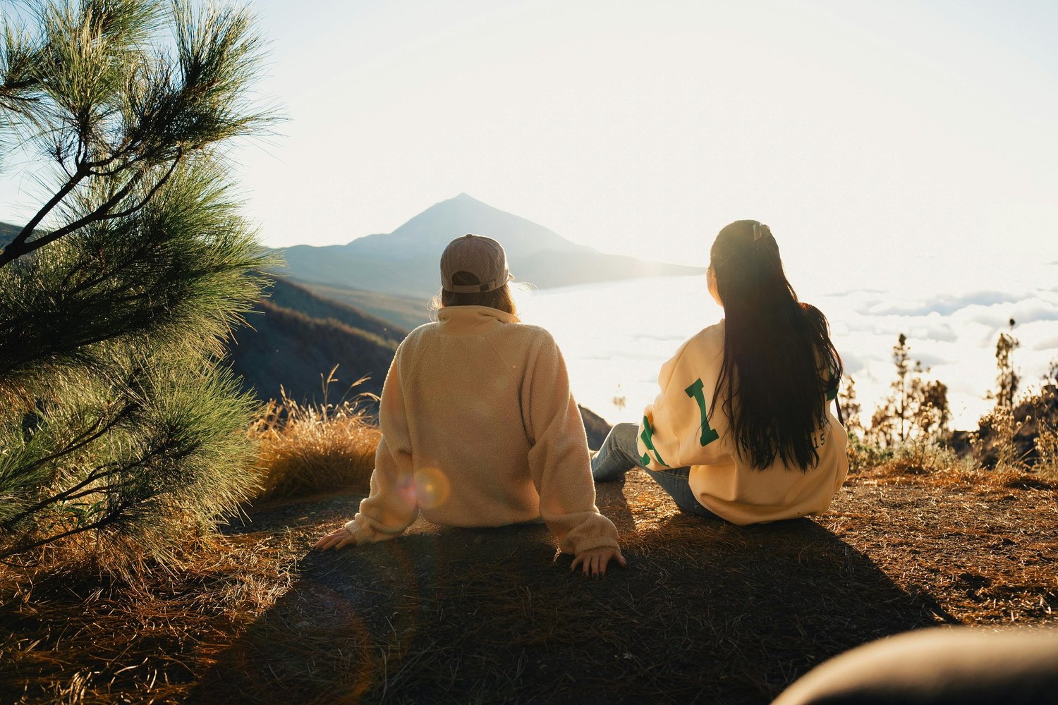 A couple sitting together watching the sunset, symbolizing connection, intimacy, and peaceful moments in a relationship.