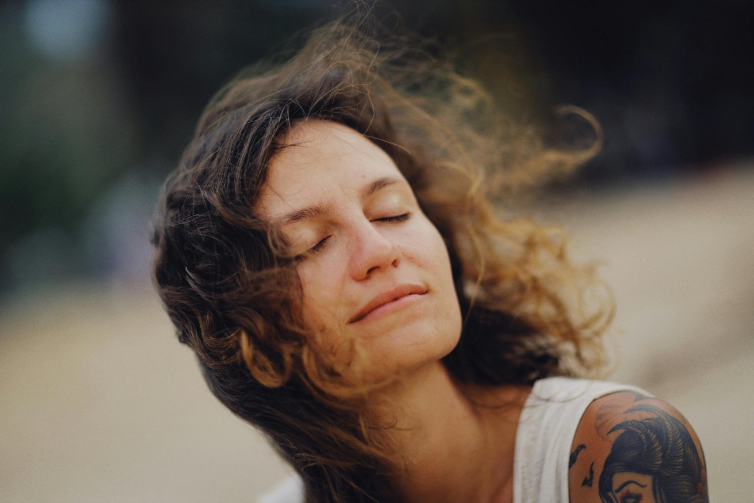 Close-up of a woman with eyes closed in a calm moment of reflection and emotional grounding