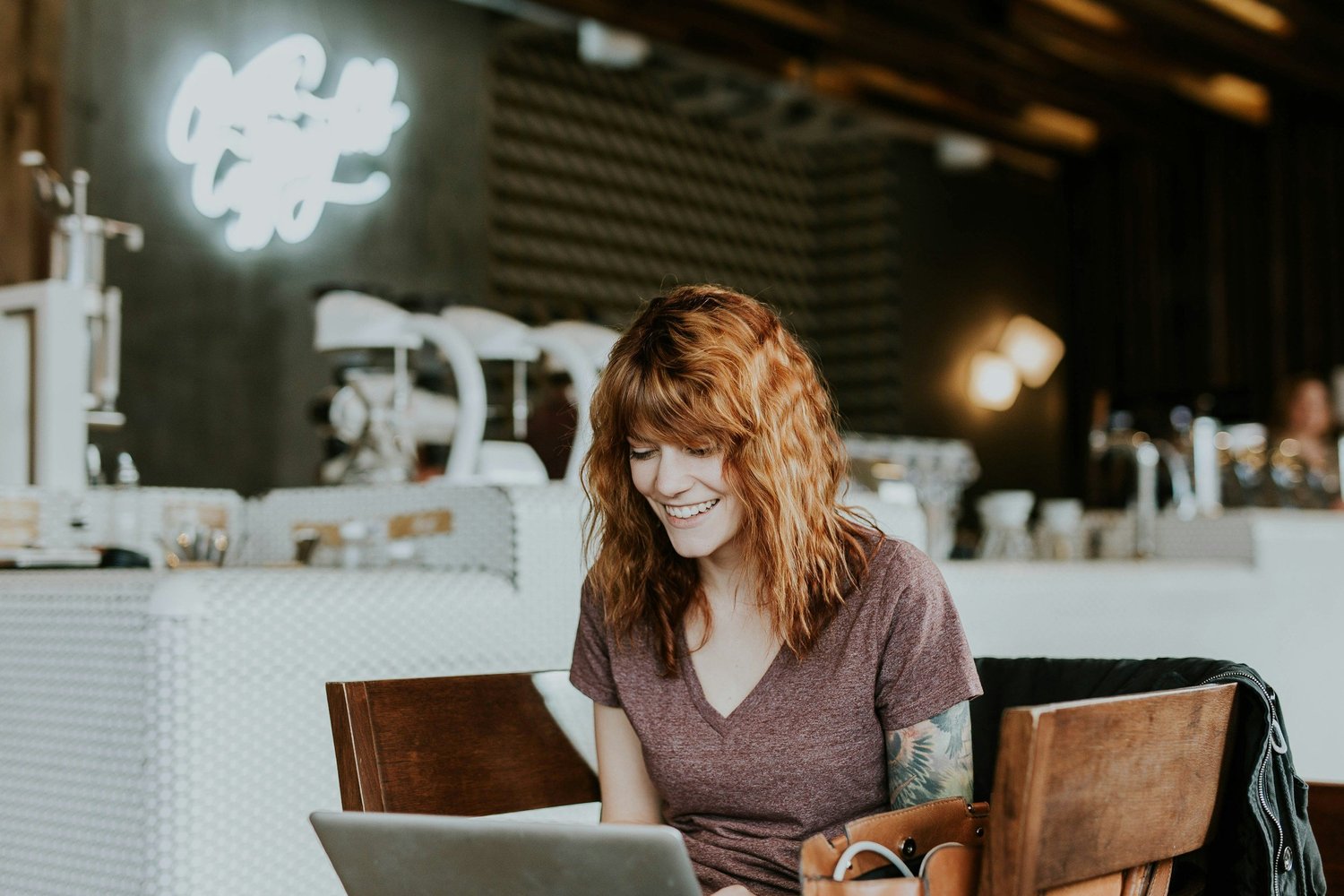 Woman working on a laptop in a café