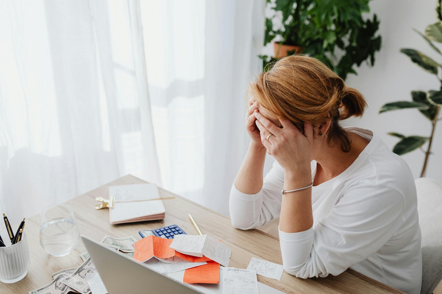 Stressed woman at her desk, overwhelmed by work and responsibilities