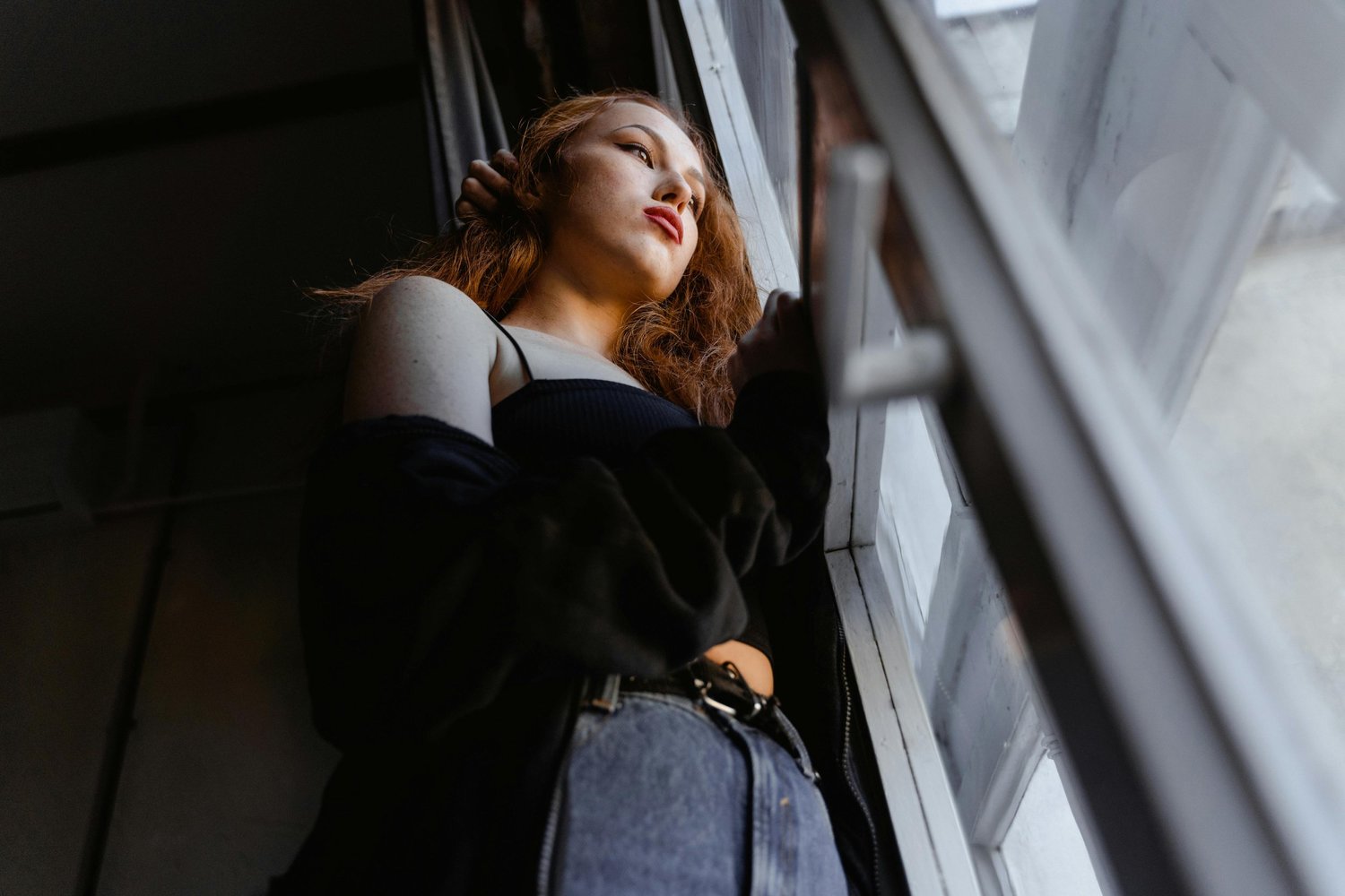 Woman resting her head against a window