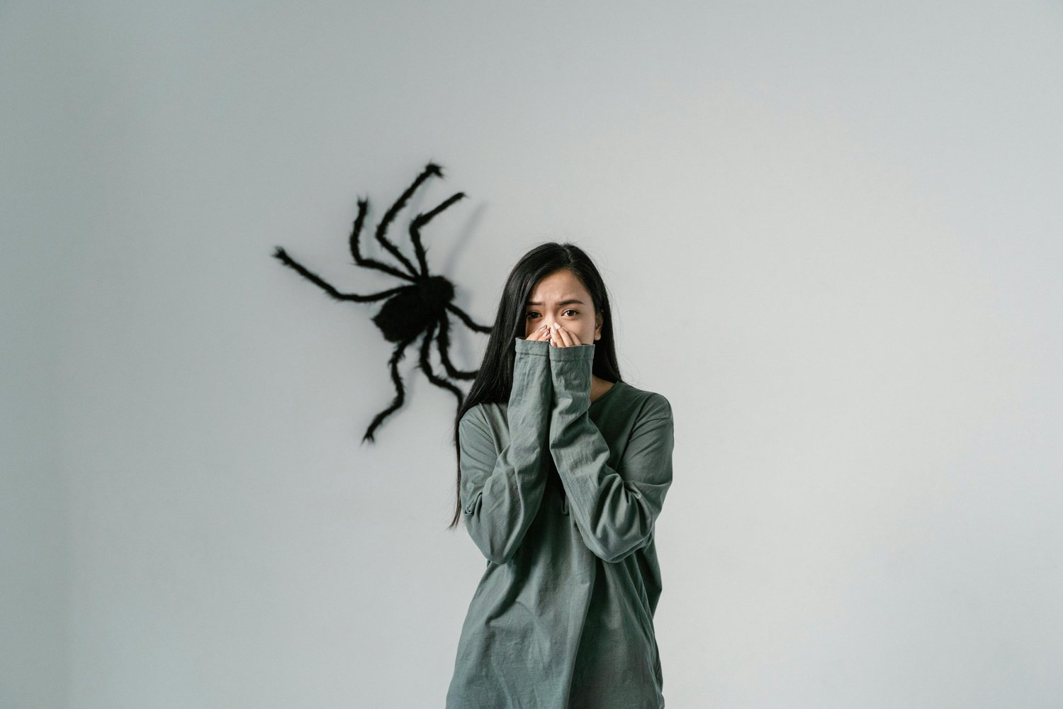Woman showing fear of a spider, illustrating phobia treatment and mental health wellness in Arizona counseling.