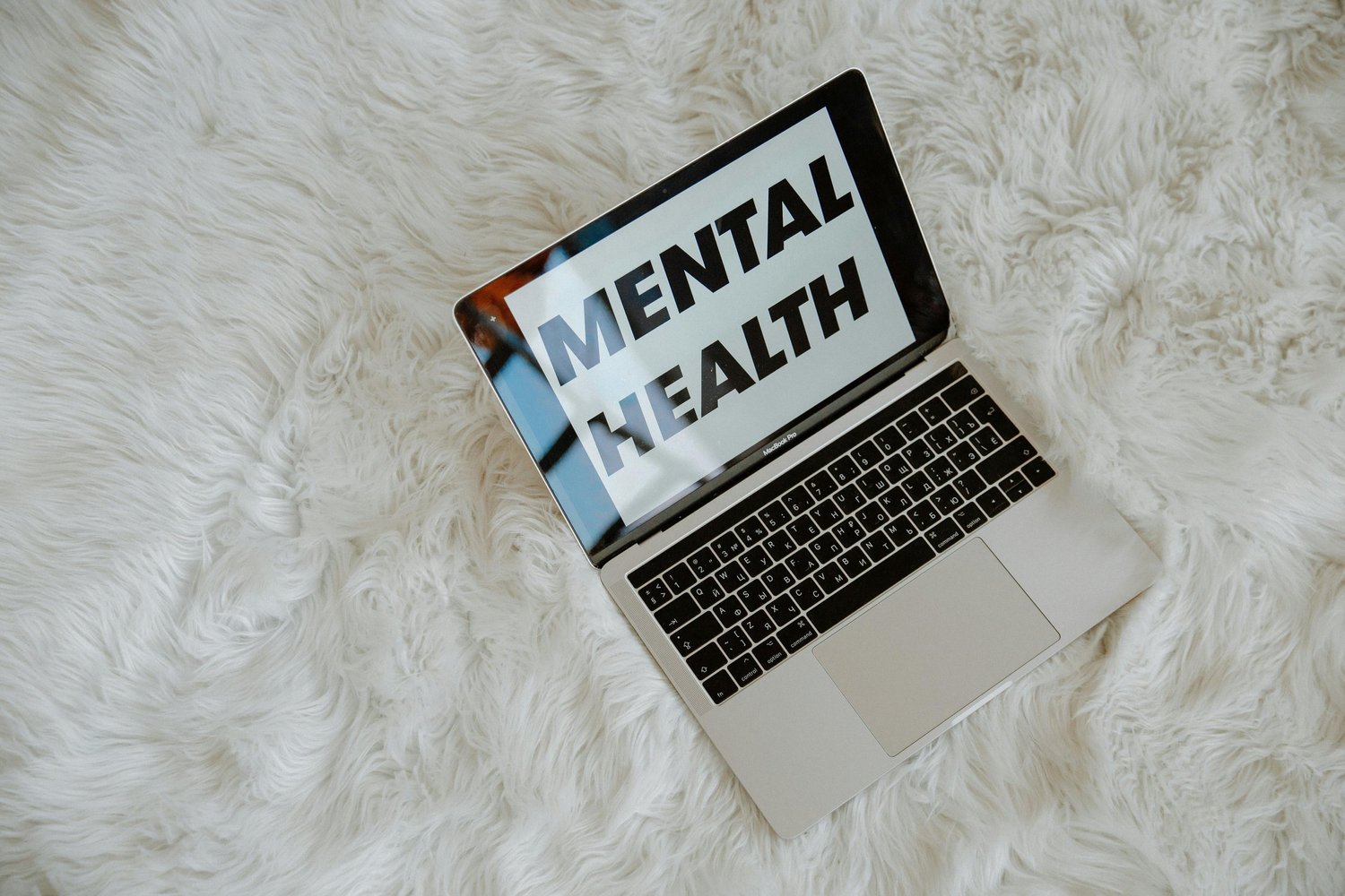 A laptop screen displaying the words “mental health” in a clean, simple interface, symbolizing online mental health awareness and support.